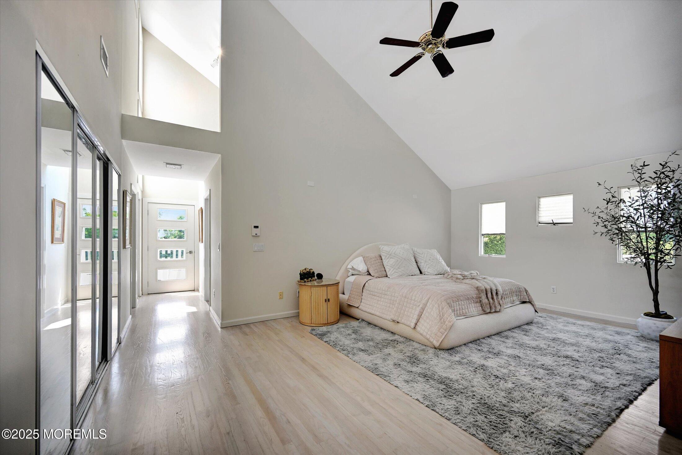 3 Woods Road West Long Branch, NJ 07764 - Photo 16 of 46 a bedroom with a bed and a chandelier