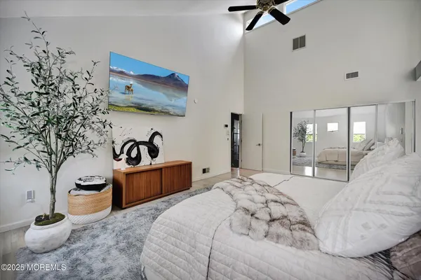 a bedroom with a bed and ceiling fan