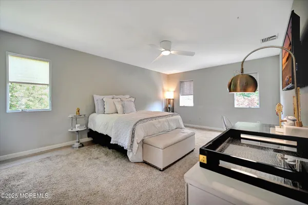 a spacious bedroom with a bed and a couch
