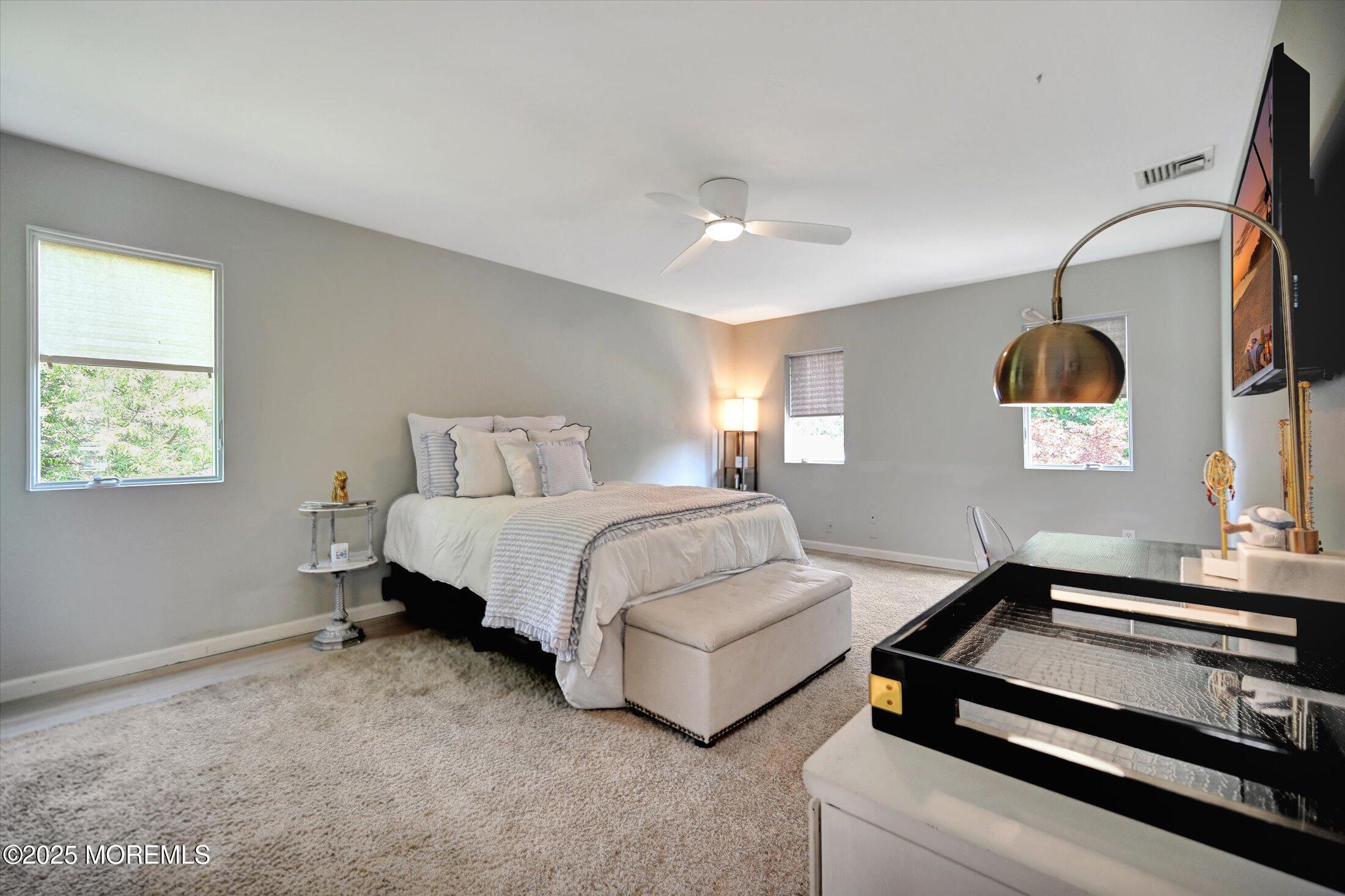 3 Woods Road West Long Branch, NJ 07764 - Photo 22 of 46 a spacious bedroom with a bed and a couch