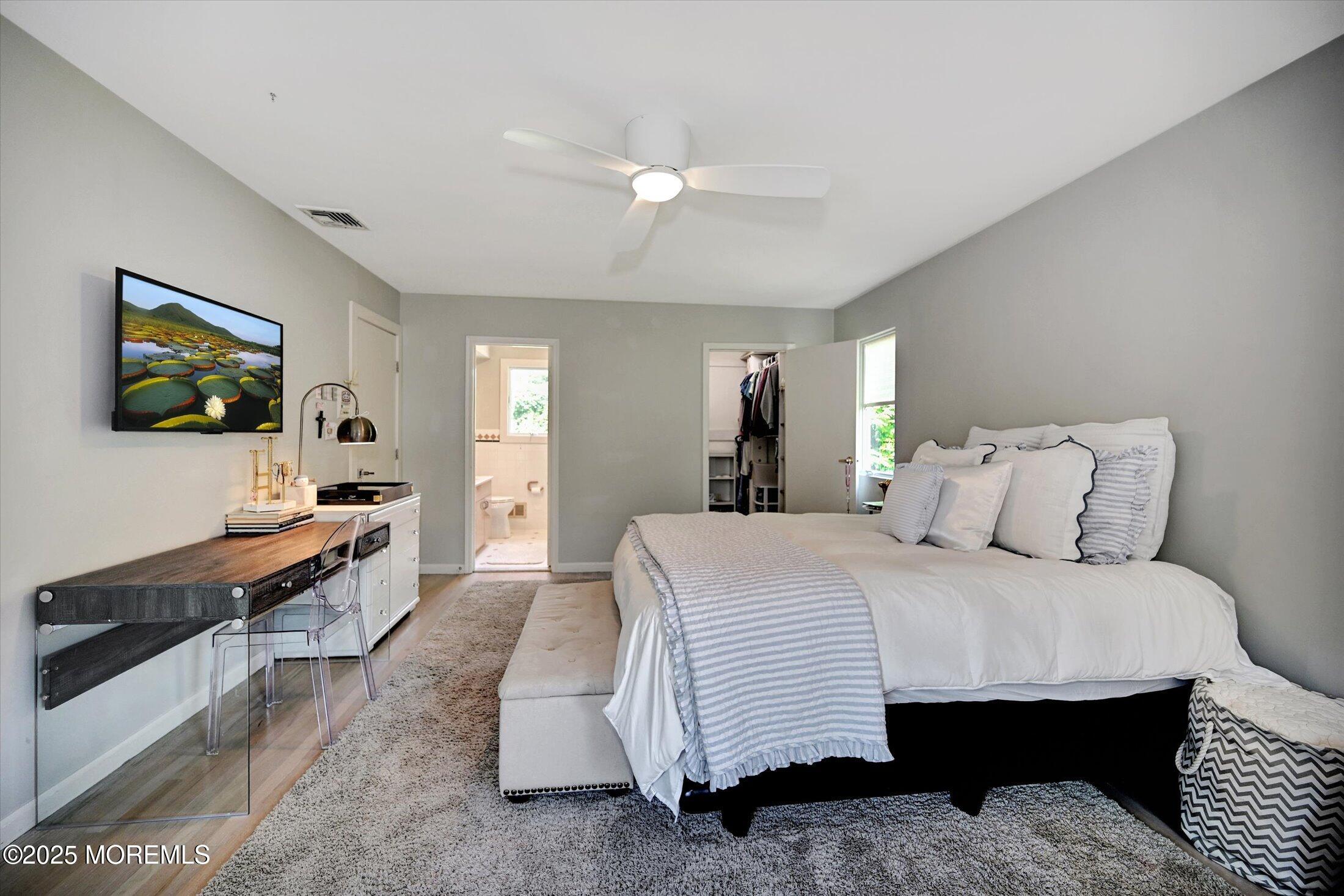 3 Woods Road West Long Branch, NJ 07764 - Photo 23 of 46 a spacious bedroom with a bed and a flat screen tv