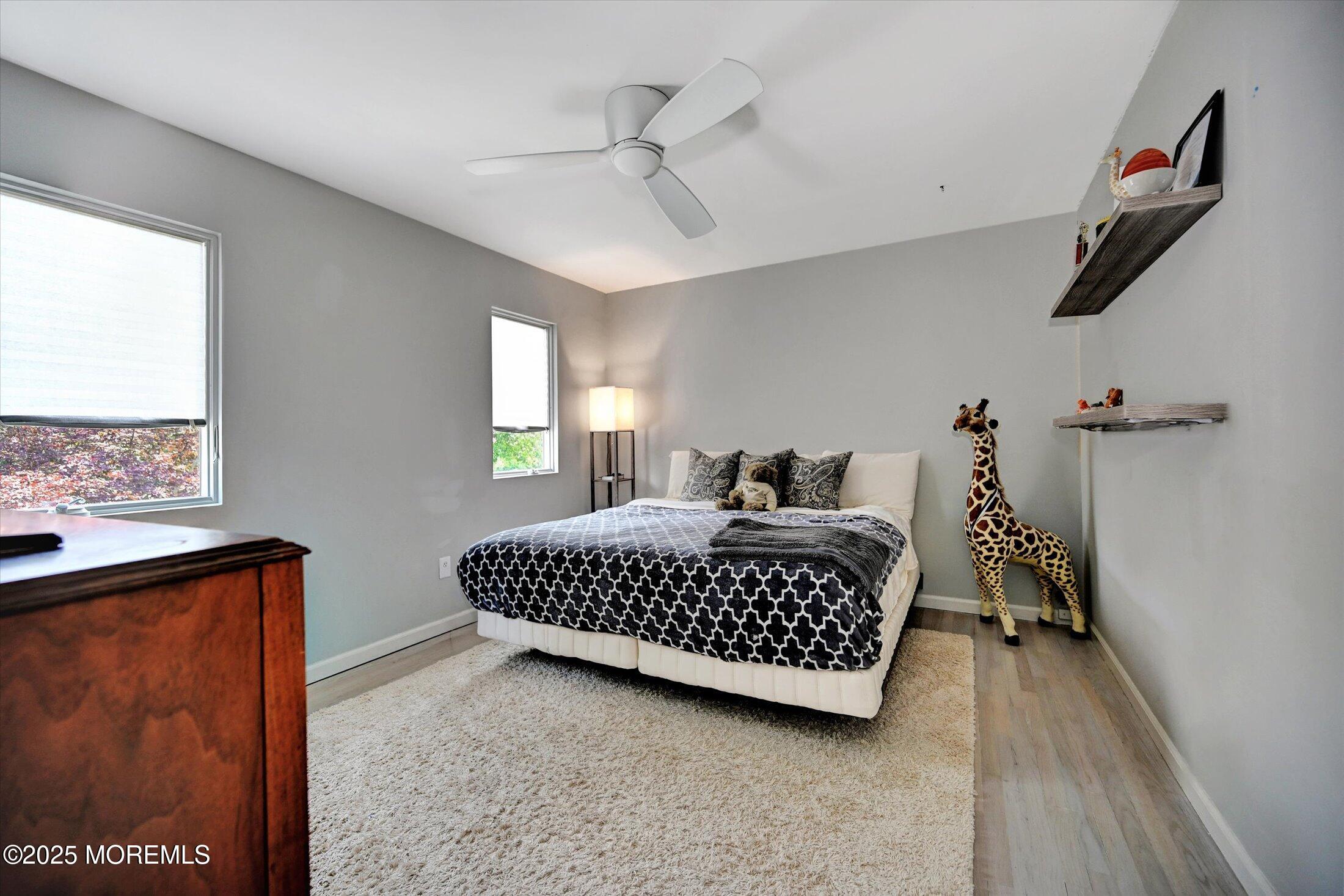 3 Woods Road West Long Branch, NJ 07764 - Photo 24 of 46 a bedroom with a bed lamp and a window