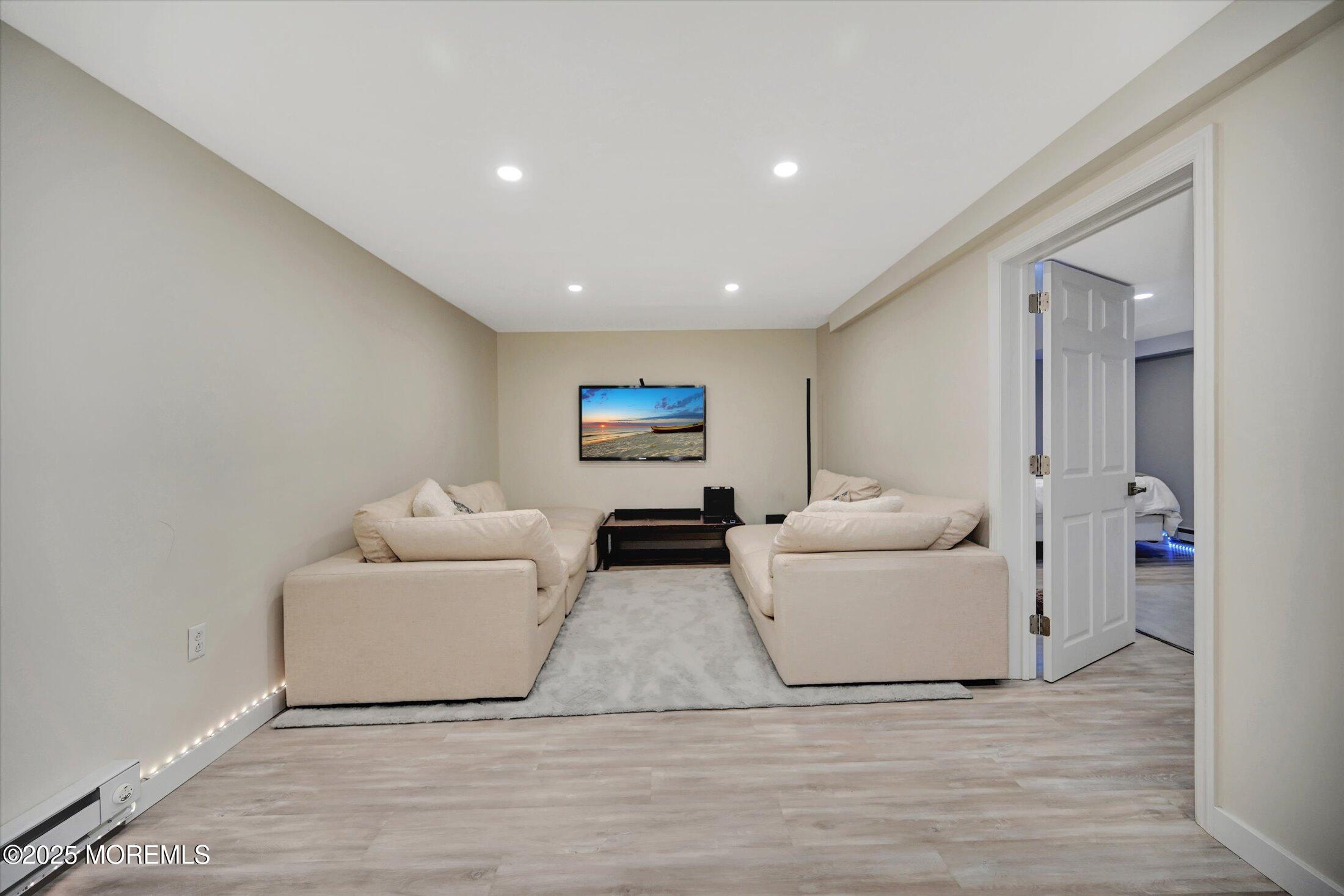 3 Woods Road West Long Branch, NJ 07764 - Photo 27 of 46 a living room with furniture and a wooden floor