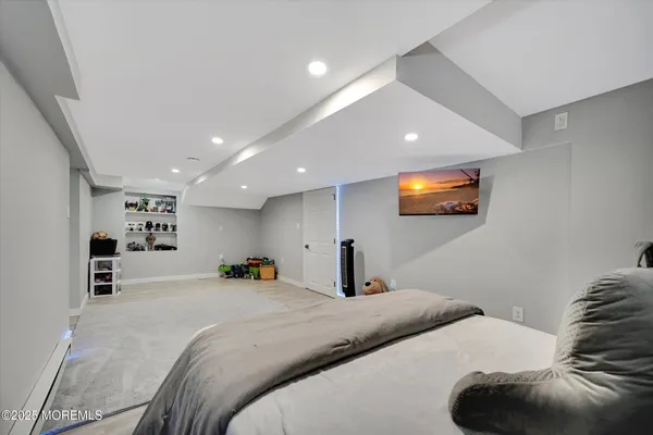 a bedroom with a large bed and a flat screen tv