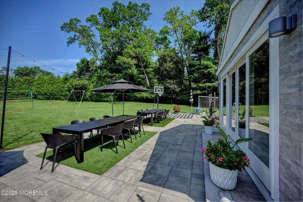 a view of a table and chairs in patio with a yard
