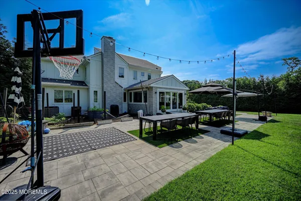 a view of a patio with table and chairs with wooden fence and plants