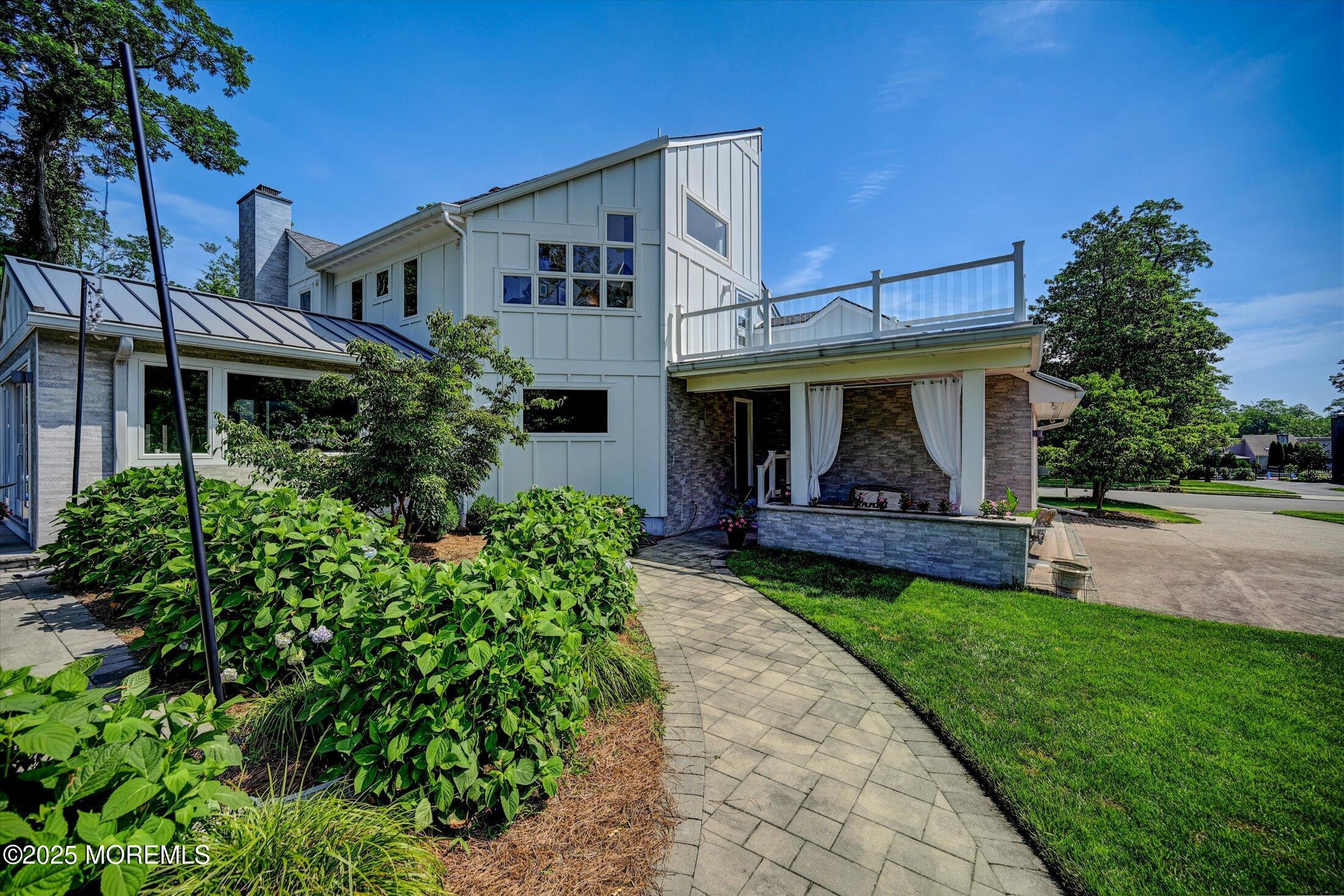 3 Woods Road West Long Branch, NJ 07764 - Photo 37 of 46 a front view of a house with garden