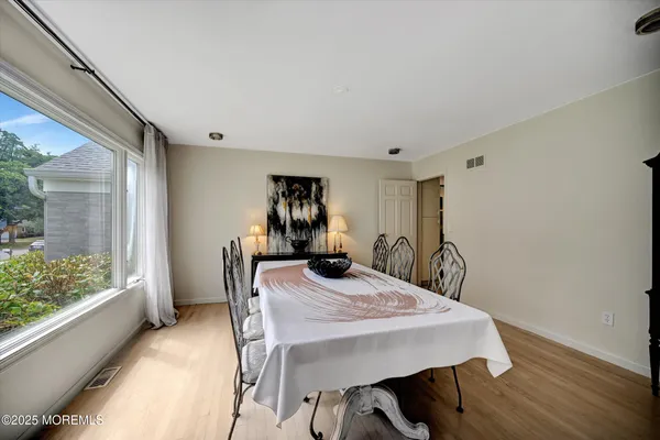 a view of a dining room with furniture and a window