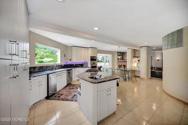 a kitchen with sink cabinets and window