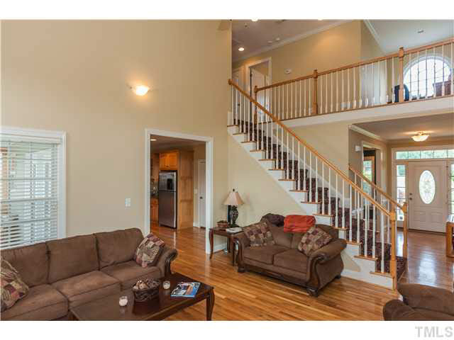 5820 Turner Store Lane Raleigh, NC 27603 - Photo 6 of 25 Shown here is the overlook balcony with upper palladium window, wood turn pickets and wood stairs with exposed wood risers. The upper landing is also wood and there is a roomy loft area that sits right inside the palladium window. Great as a reading nook!