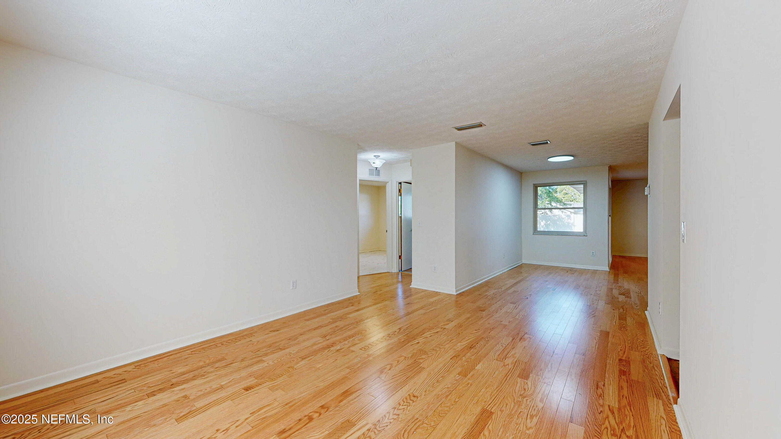 2474 Summer Tree Road East Jacksonville, FL 32246 - Photo 3 of 42 a view of empty room with wooden floor and fan