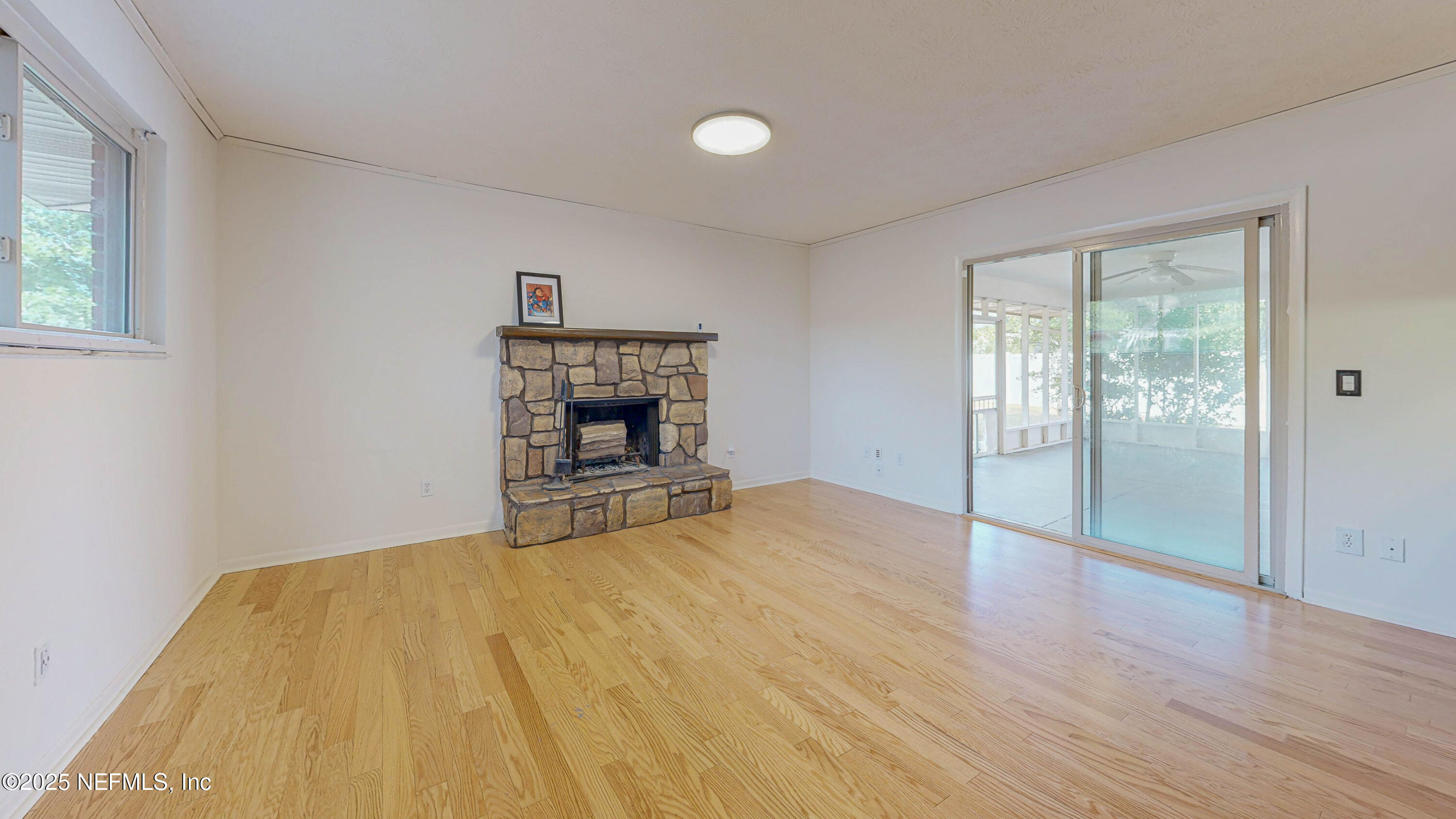 2474 Summer Tree Road East Jacksonville, FL 32246 - Photo 6 of 42 a view of empty room with wooden floor and fireplace