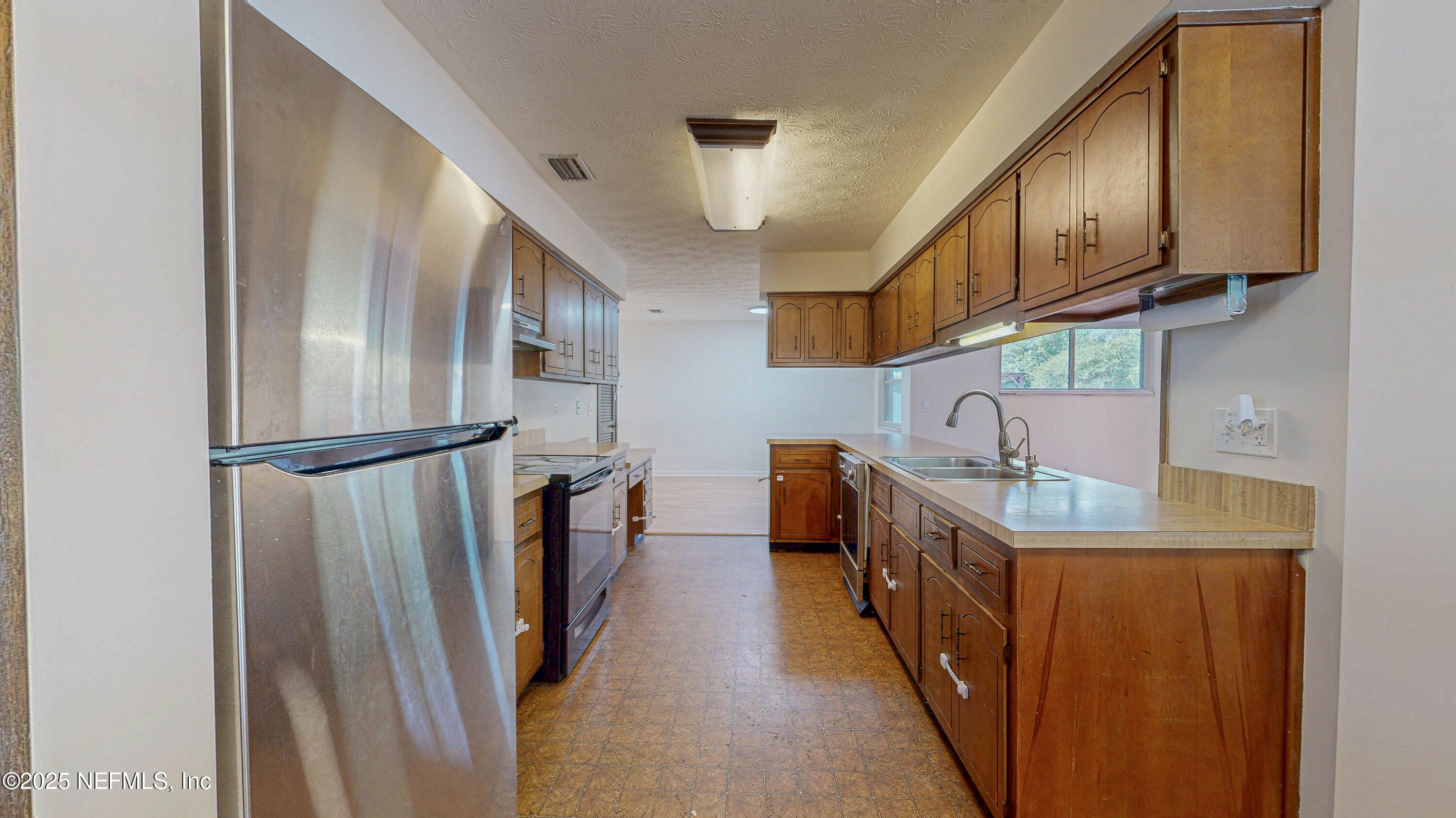 2474 Summer Tree Road East Jacksonville, FL 32246 - Photo 10 of 42 a kitchen with stainless steel appliances granite countertop a refrigerator and a sink