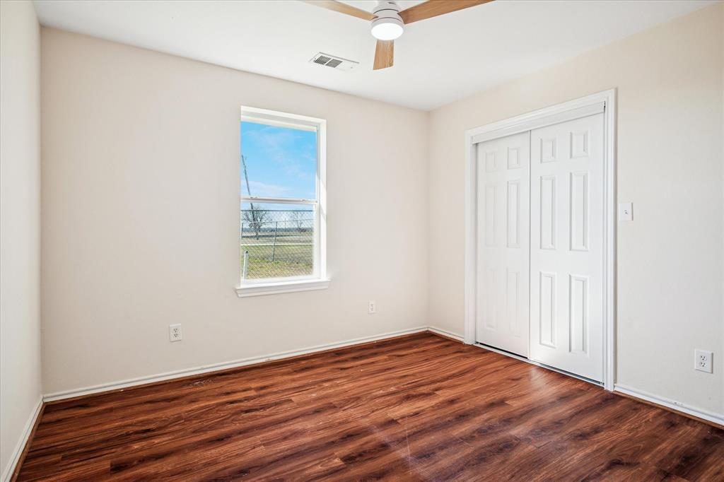 112 Sebastian Lane Josephine, TX 75173 - Photo 12 of 15 an empty room with wooden floor and windows