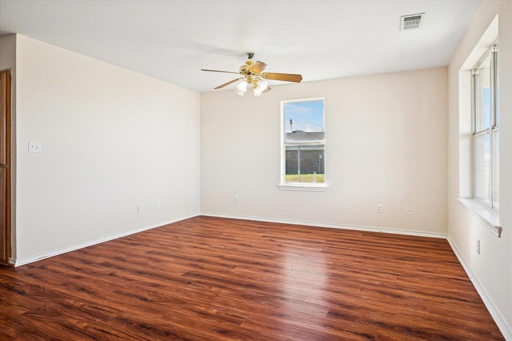 112 Sebastian Lane Josephine, TX 75173 - Photo 3 of 15 wooden floor in an empty room with a window