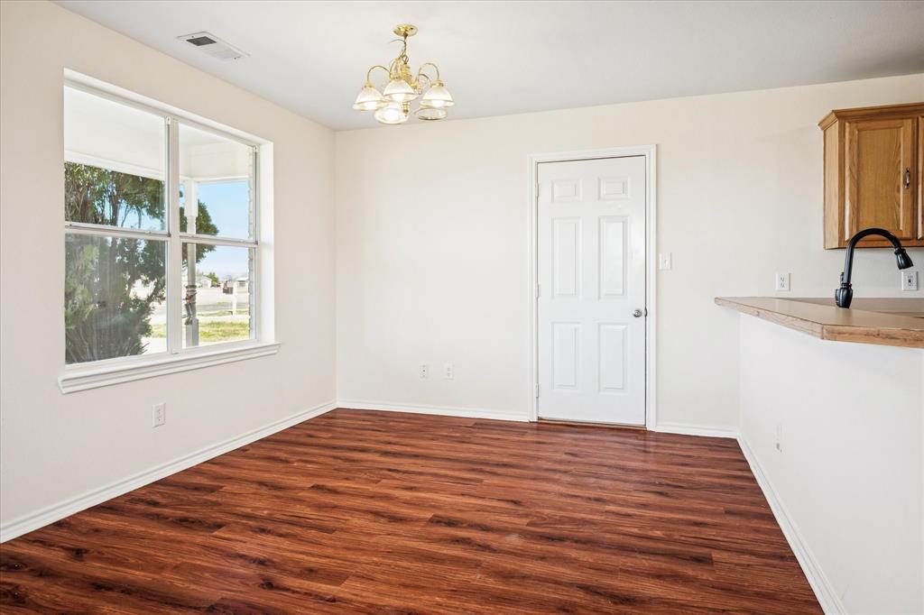 112 Sebastian Lane Josephine, TX 75173 - Photo 5 of 15 a view of a bedroom with wooden floor and window