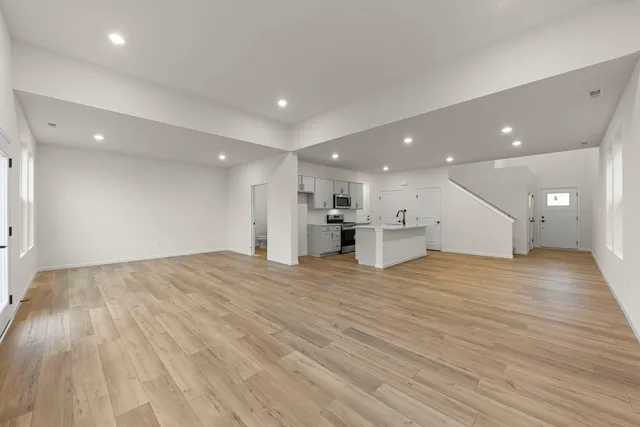 a view of kitchen with kitchen island and stainless steel appliances