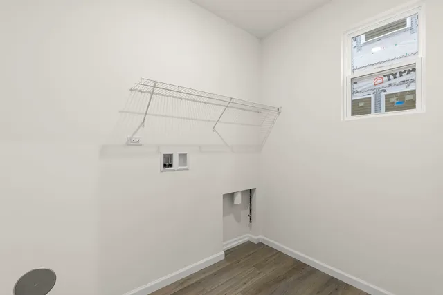 a view of a room with wooden floor and fan