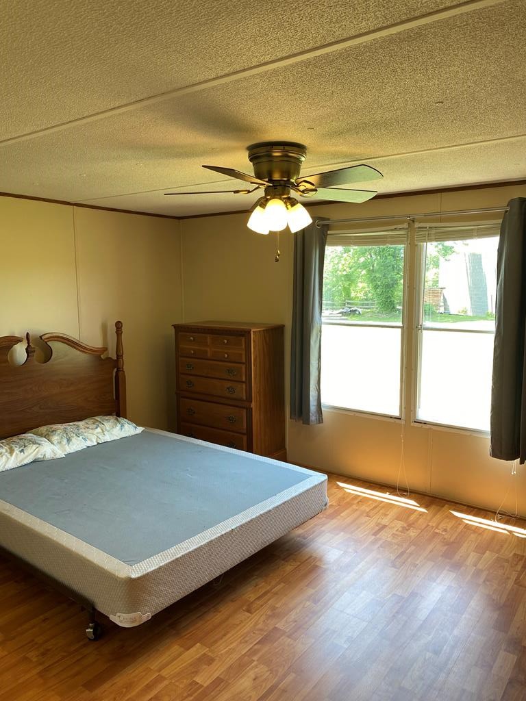 313 Lonesome Pine Road Bybee, TN 37713 - Photo 20 of 48 a bedroom with a bed and a chandelier