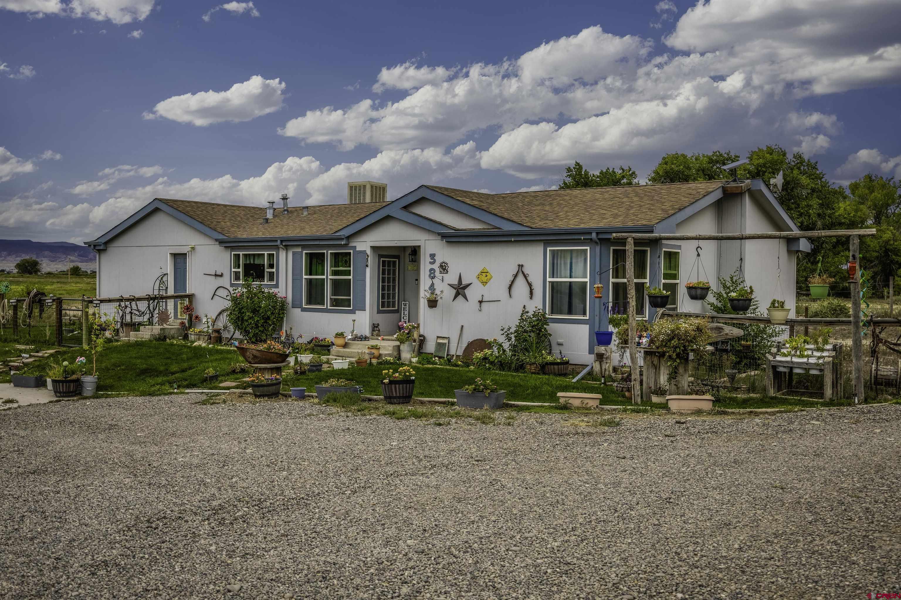 3847 5725th Road Olathe, CO 81425 - Photo 1 of 26 a front view of a house with garden