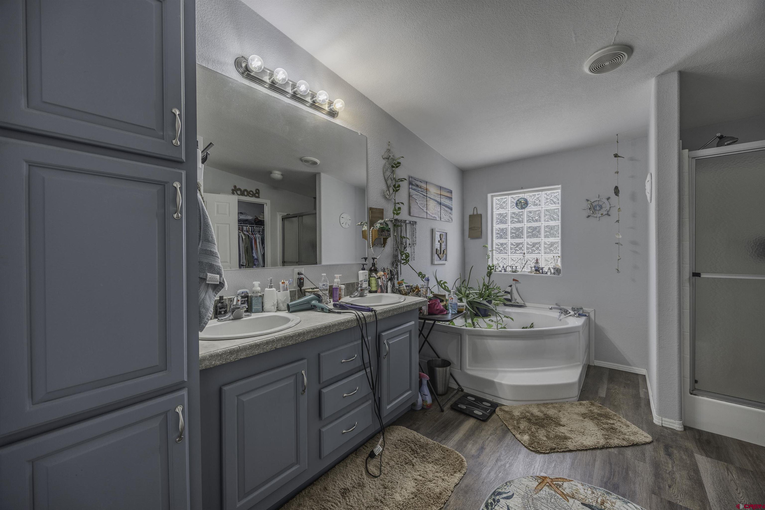 3847 5725th Road Olathe, CO 81425 - Photo 11 of 26 a bathroom with a sink mirror and toilet