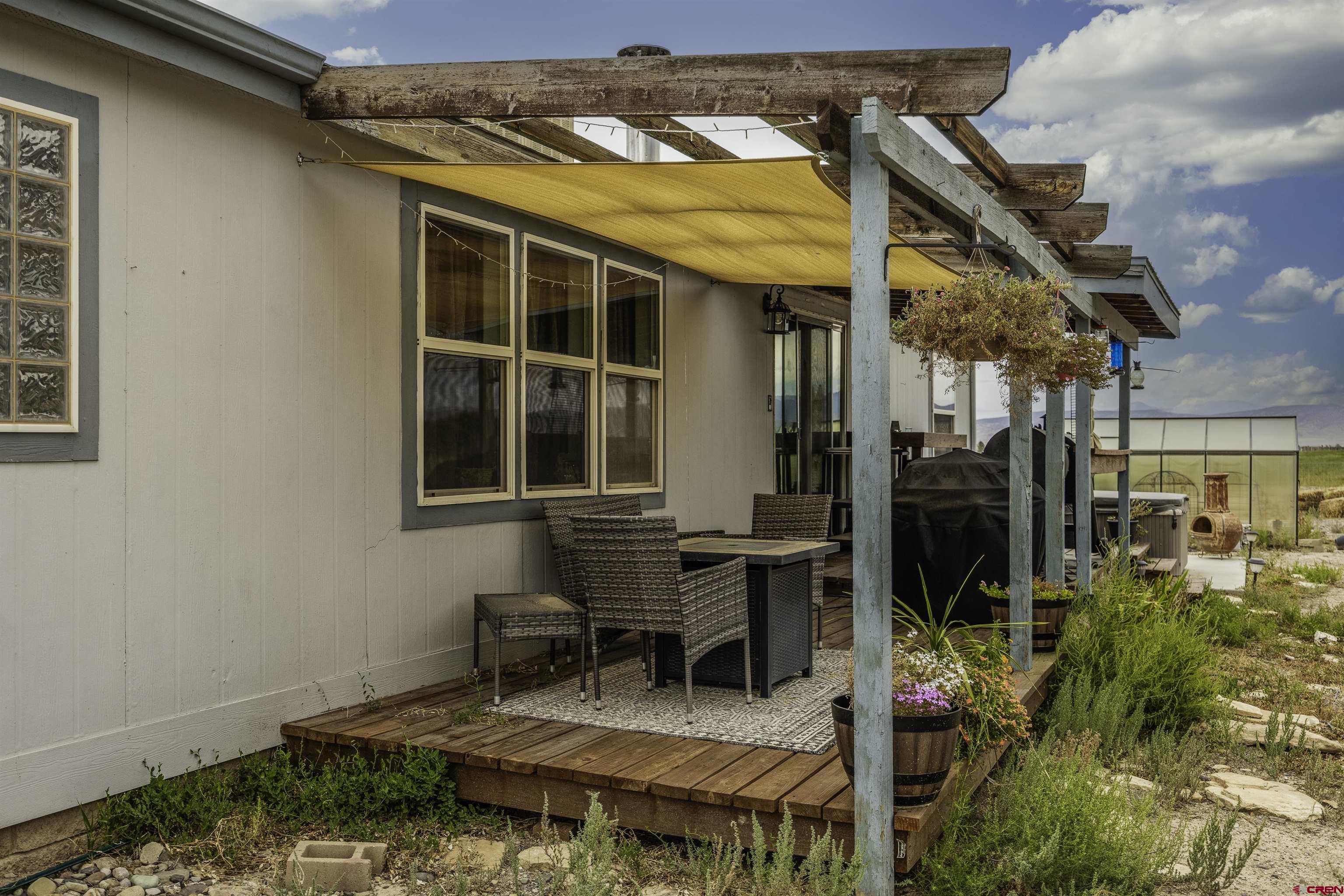 3847 5725th Road Olathe, CO 81425 - Photo 16 of 26 a backyard of a house with table and chairs