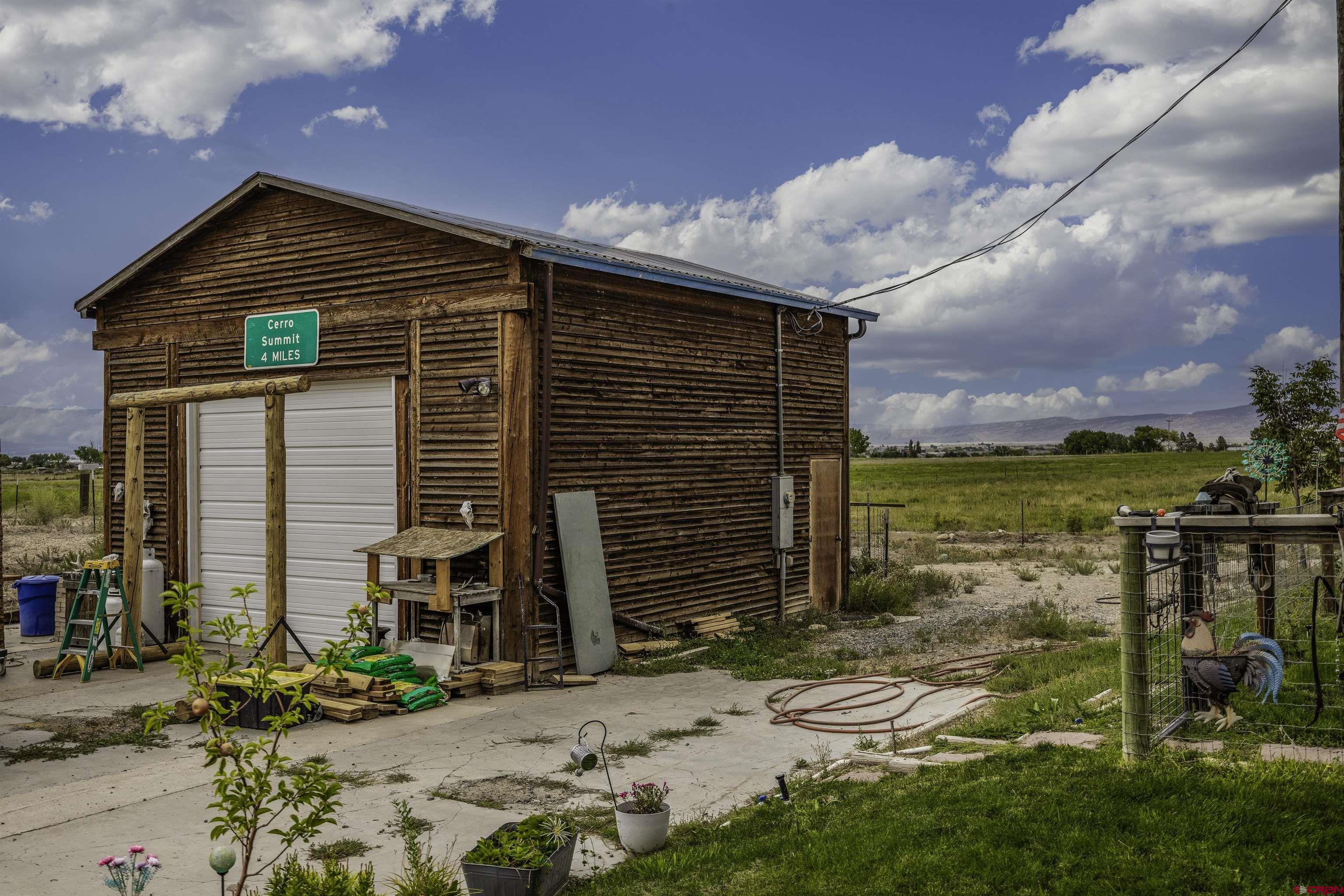 3847 5725th Road Olathe, CO 81425 - Photo 19 of 26 a view of a house with a yard