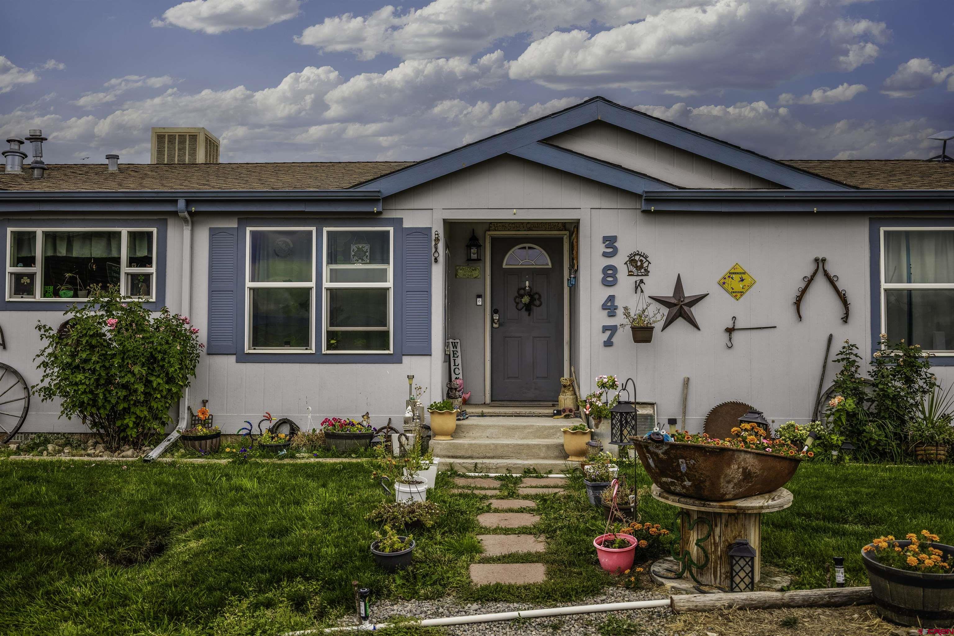 3847 5725th Road Olathe, CO 81425 - Photo 2 of 26 a front view of a house with garden