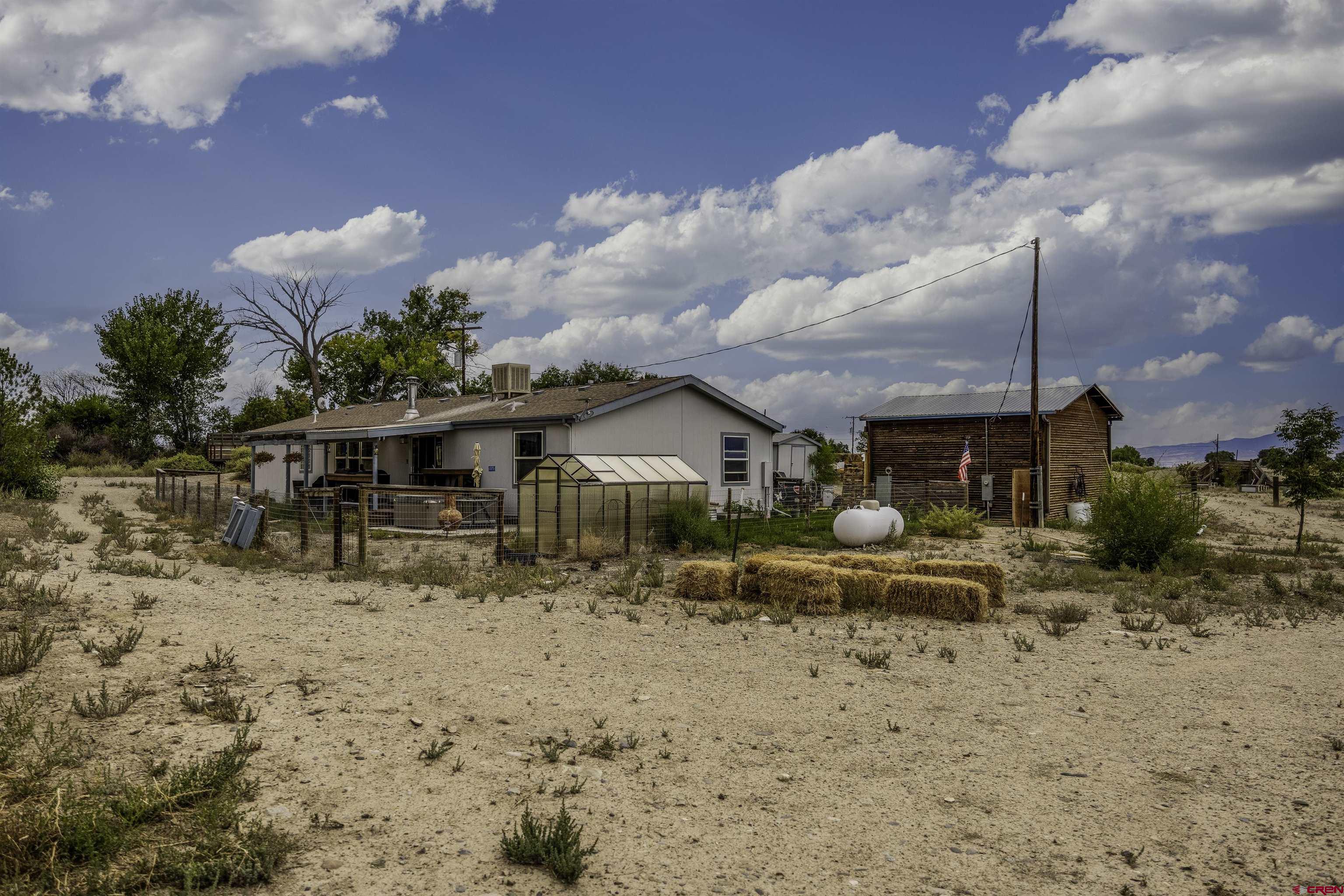 3847 5725th Road Olathe, CO 81425 - Photo 26 of 26 a front view of a house with a yard and covered with snow