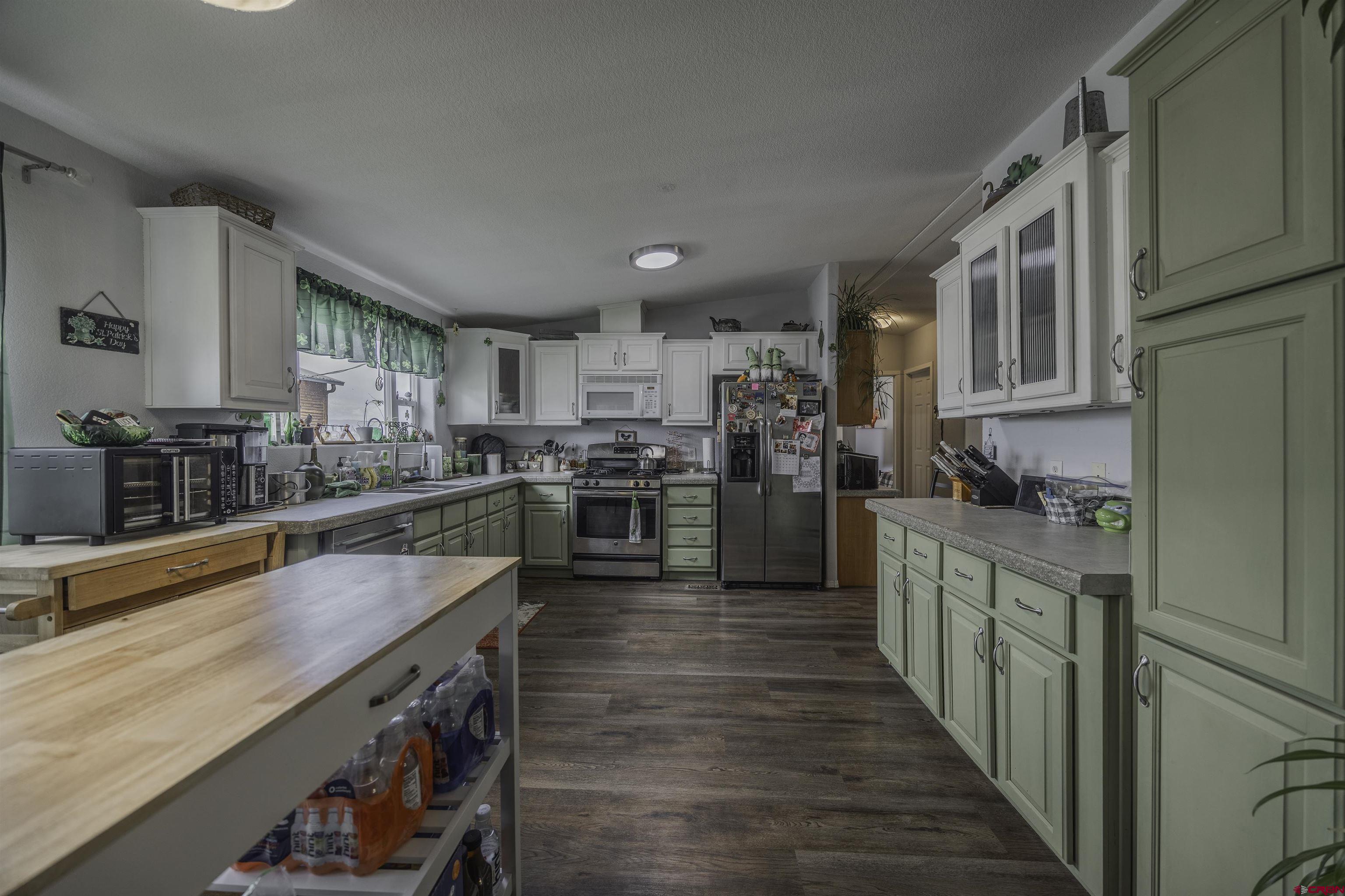 3847 5725th Road Olathe, CO 81425 - Photo 4 of 26 a kitchen with stainless steel appliances granite countertop lots of counter top space and wooden floor