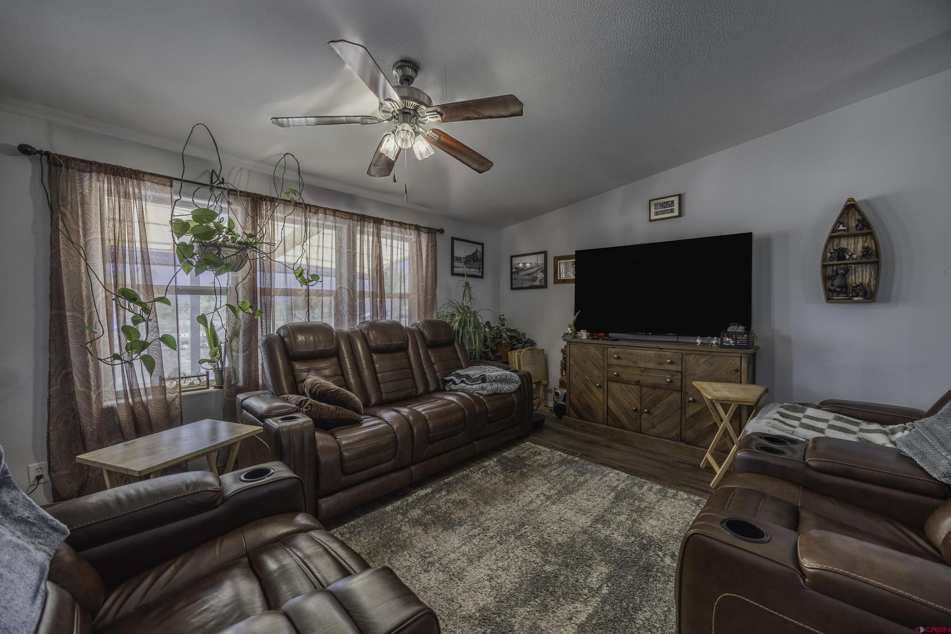 3847 5725th Road Olathe, CO 81425 - Photo 6 of 26 a living room with furniture and a flat screen tv