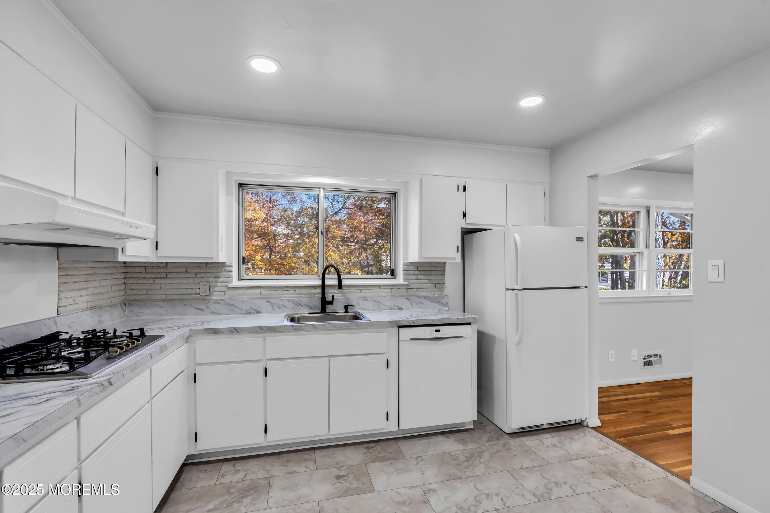 16 Burdge Drive Howell, NJ 07731 - Photo 14 of 43 a kitchen with a sink a refrigerator a window and cabinets