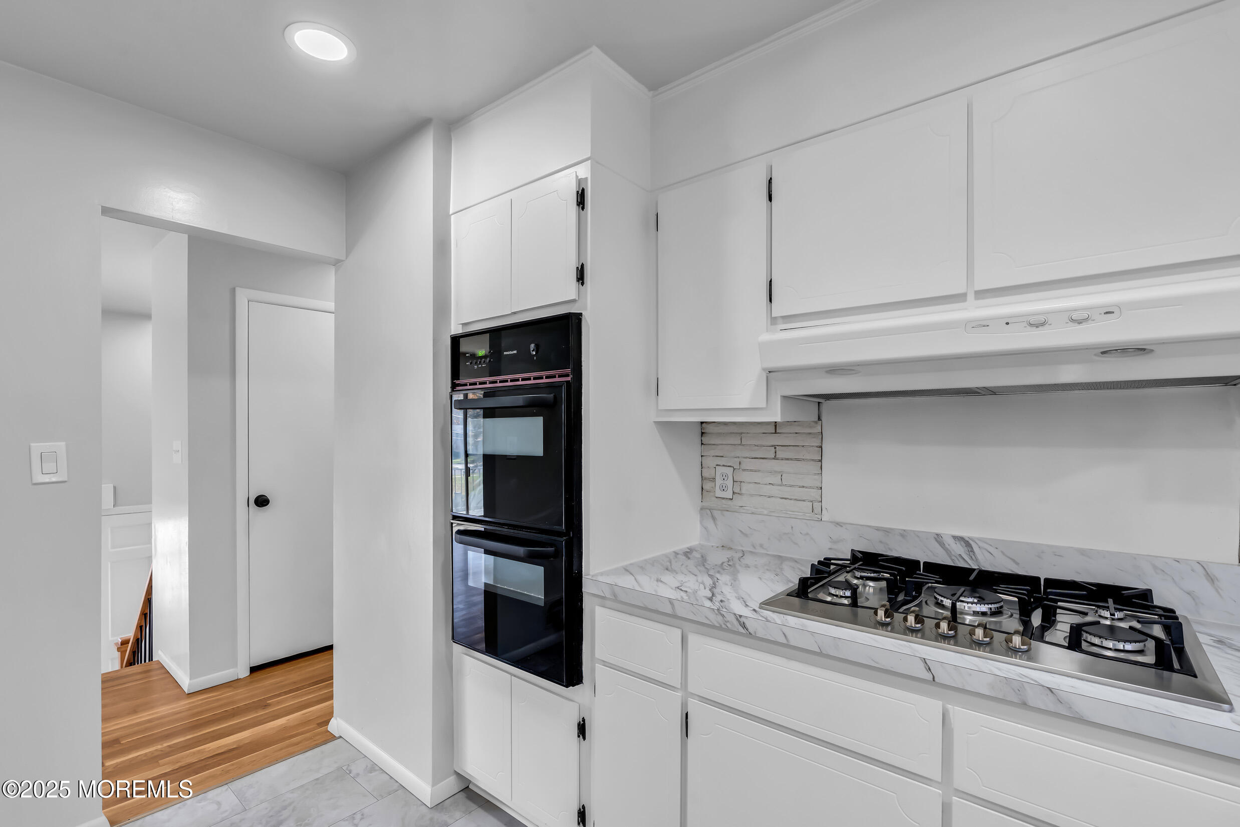 16 Burdge Drive Howell, NJ 07731 - Photo 17 of 43 a kitchen with white cabinets and appliances
