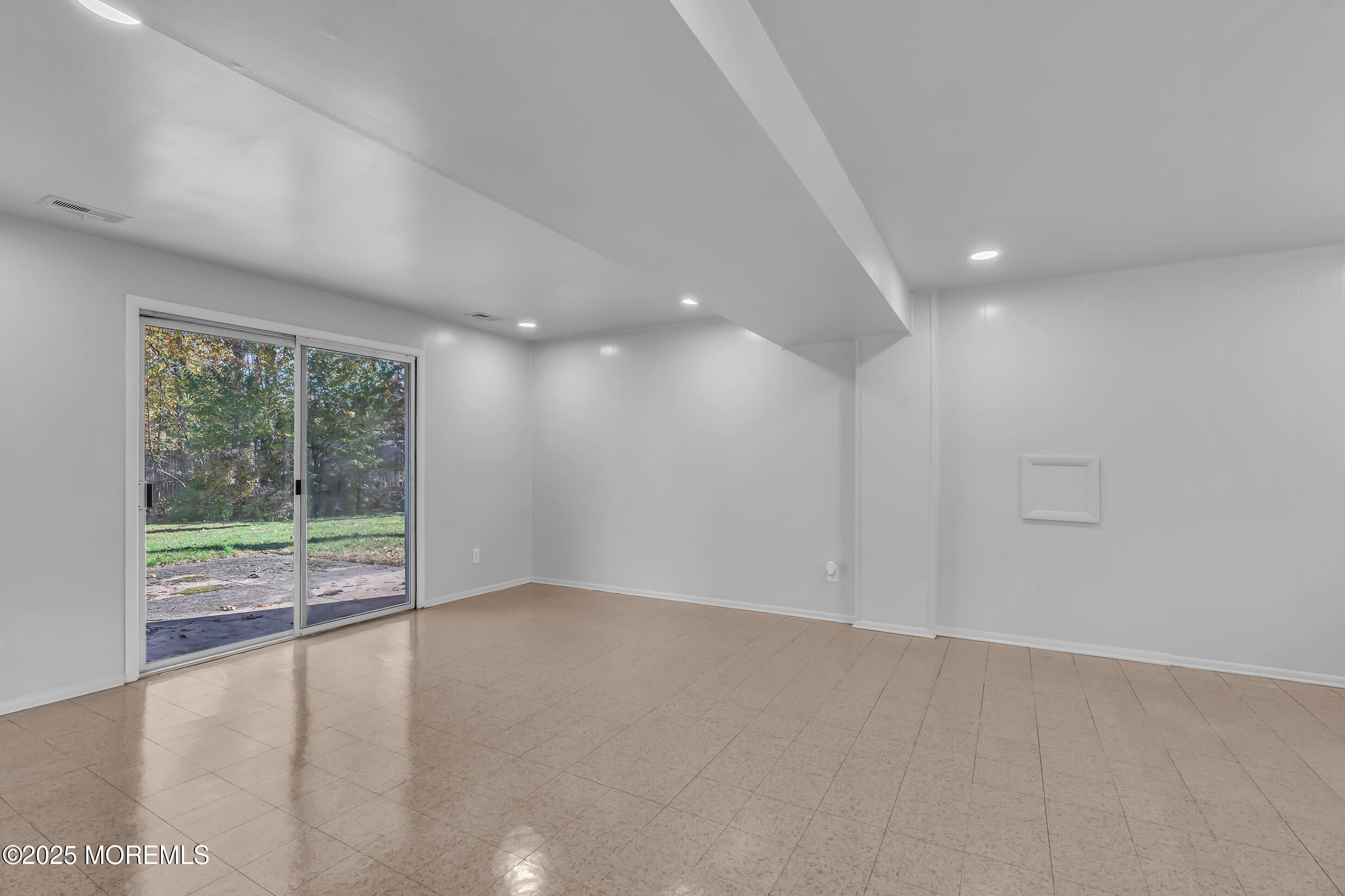 16 Burdge Drive Howell, NJ 07731 - Photo 26 of 43 a view of an empty room with wooden floor and a window