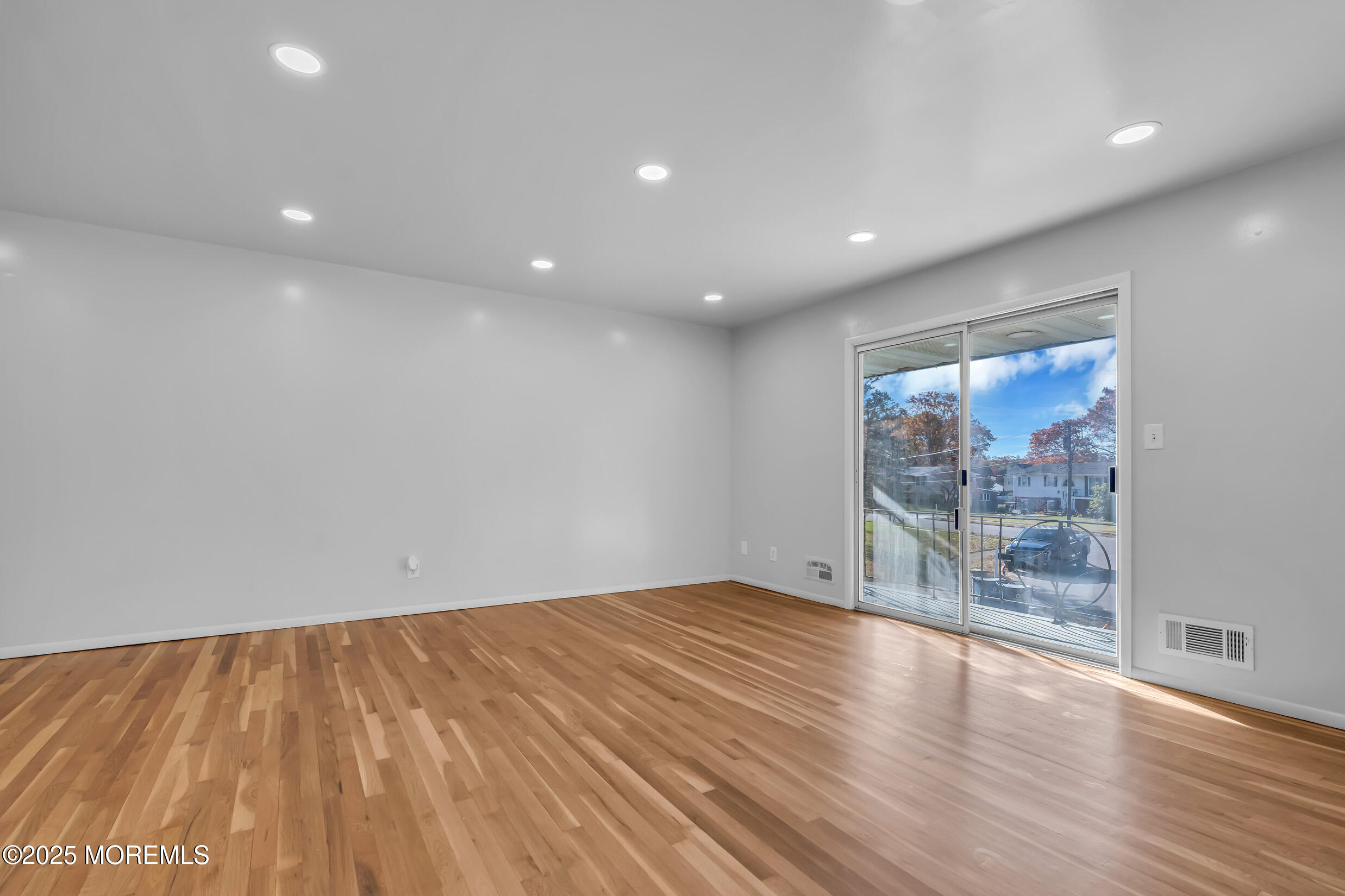 16 Burdge Drive Howell, NJ 07731 - Photo 4 of 43 a view of an empty room with wooden floor and a window