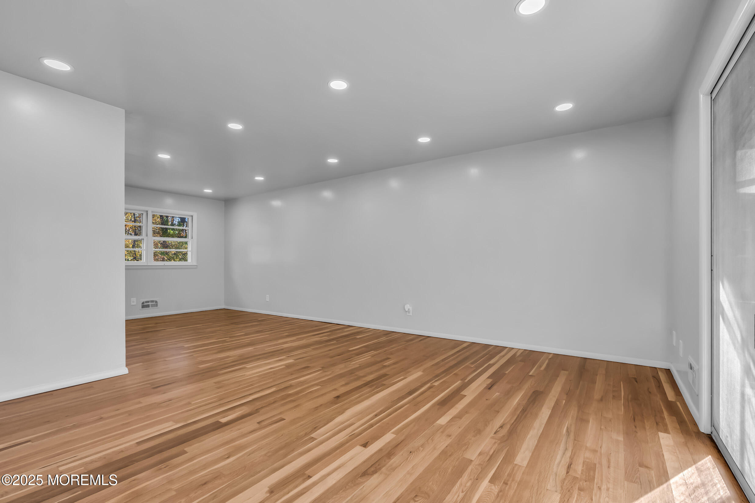 16 Burdge Drive Howell, NJ 07731 - Photo 7 of 43 an empty room with wooden floor and windows