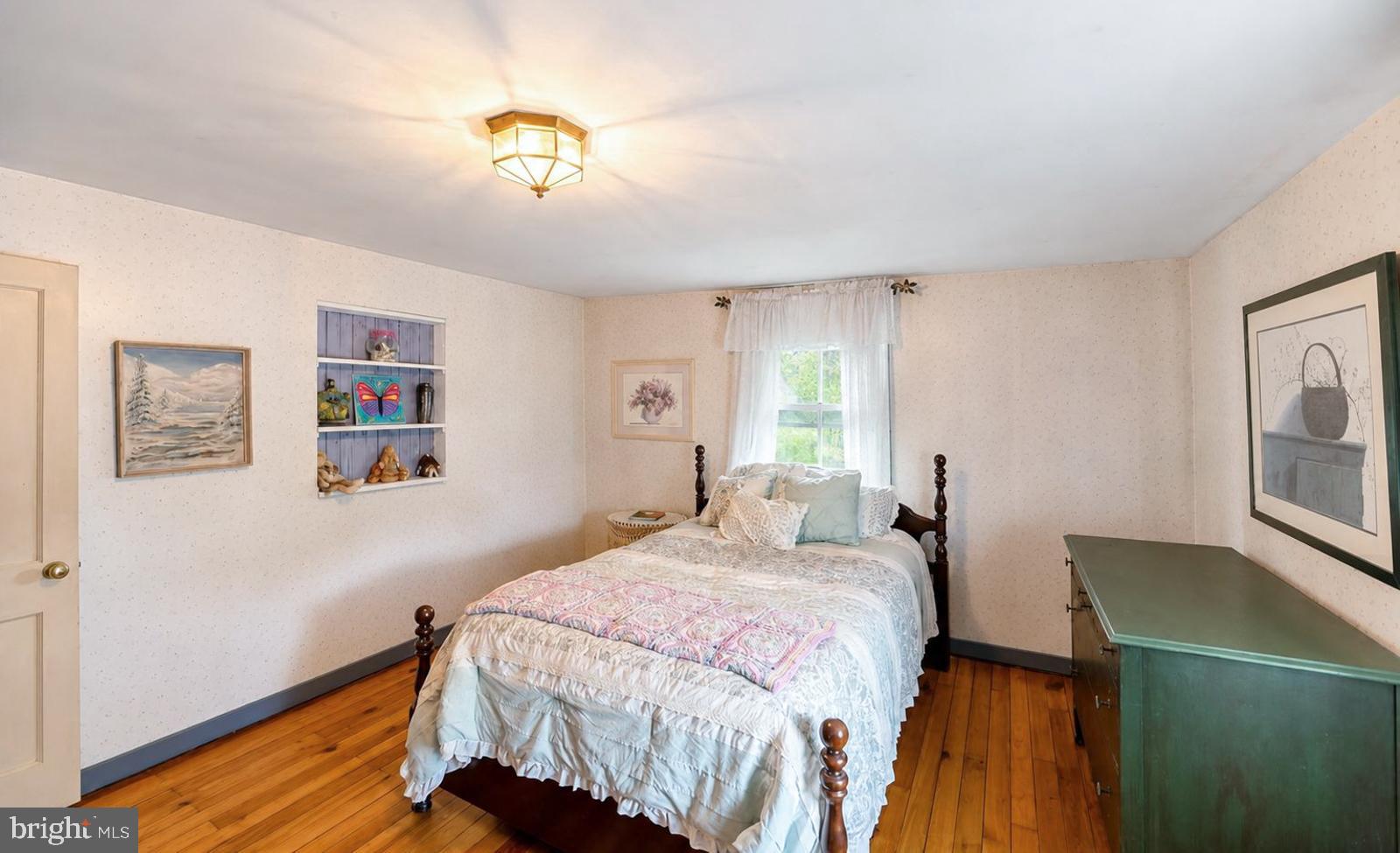 222 Blue School Road Perkasie, PA 18944 - Photo 37 of 77 a bedroom with a bed and a chandelier