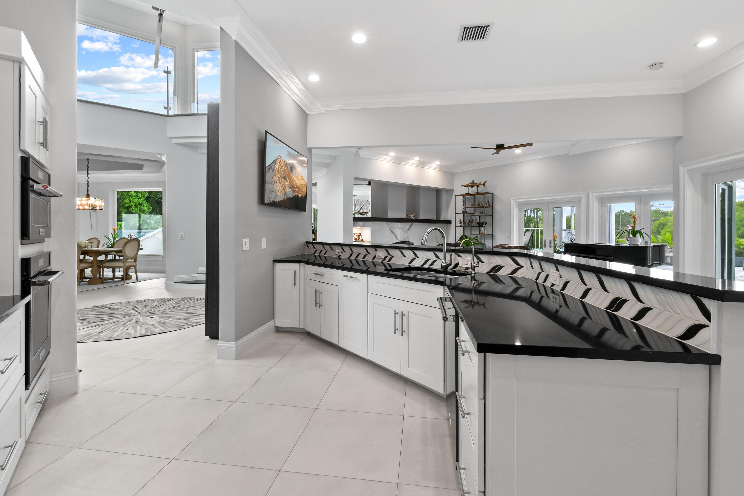 10561 Southeast Le Parc Jupiter, FL 33469 - Photo 25 of 80 a kitchen with stainless steel appliances granite countertop a sink and a stove