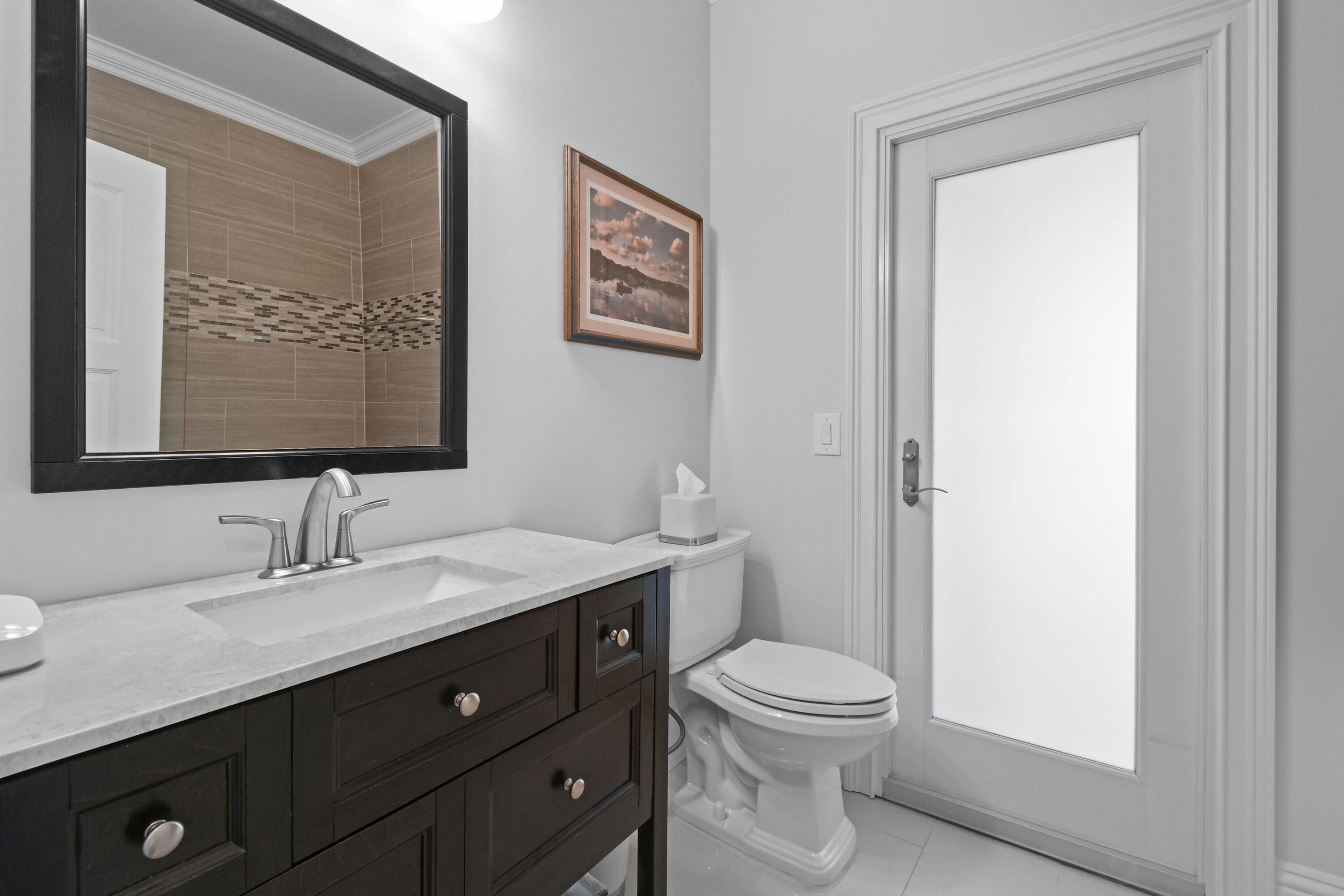 10561 Southeast Le Parc Jupiter, FL 33469 - Photo 38 of 80 a bathroom with a toilet a sink and mirror