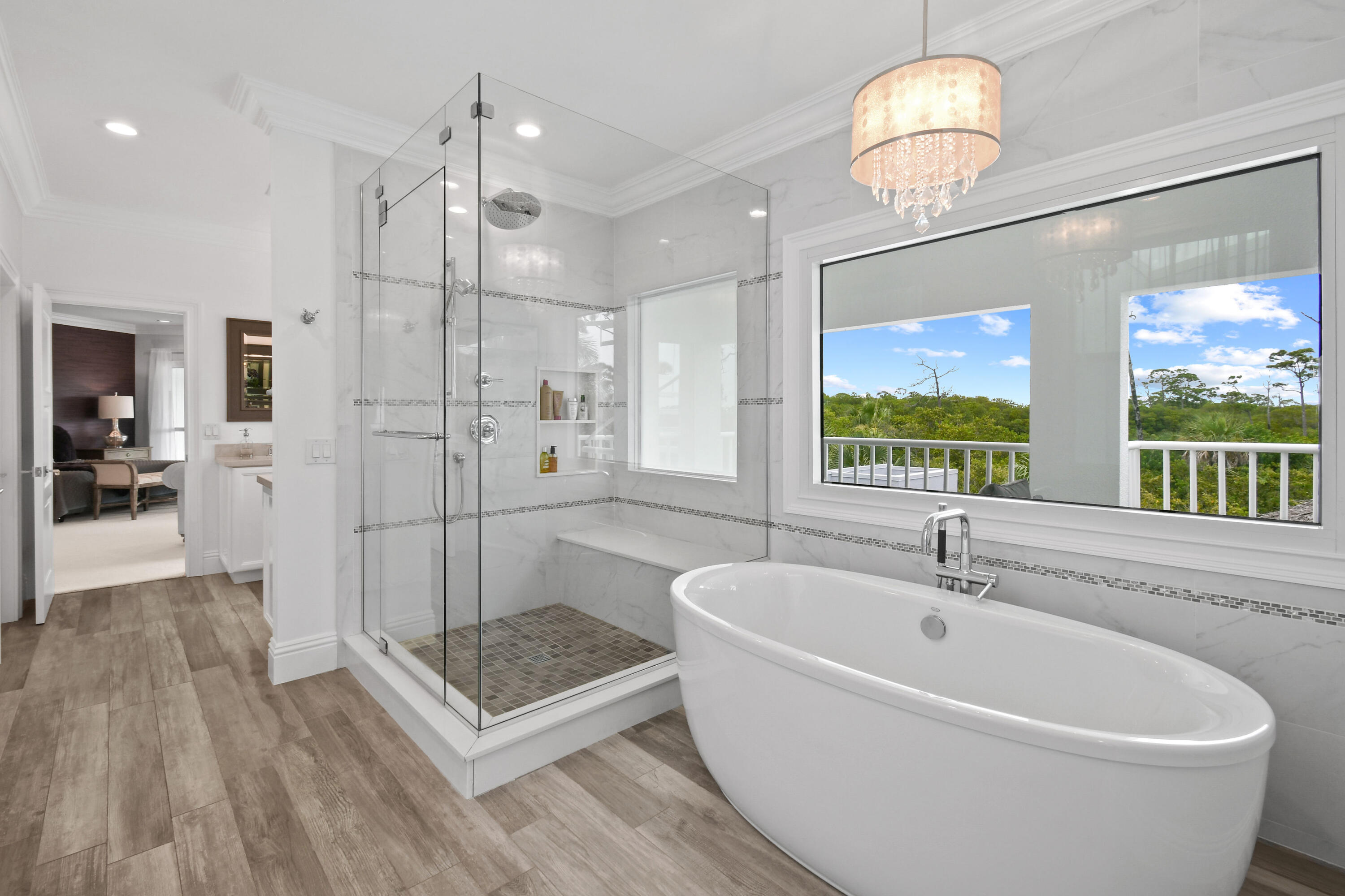 10561 Southeast Le Parc Jupiter, FL 33469 - Photo 56 of 80 a spacious bathroom with a large tub a window and glass door