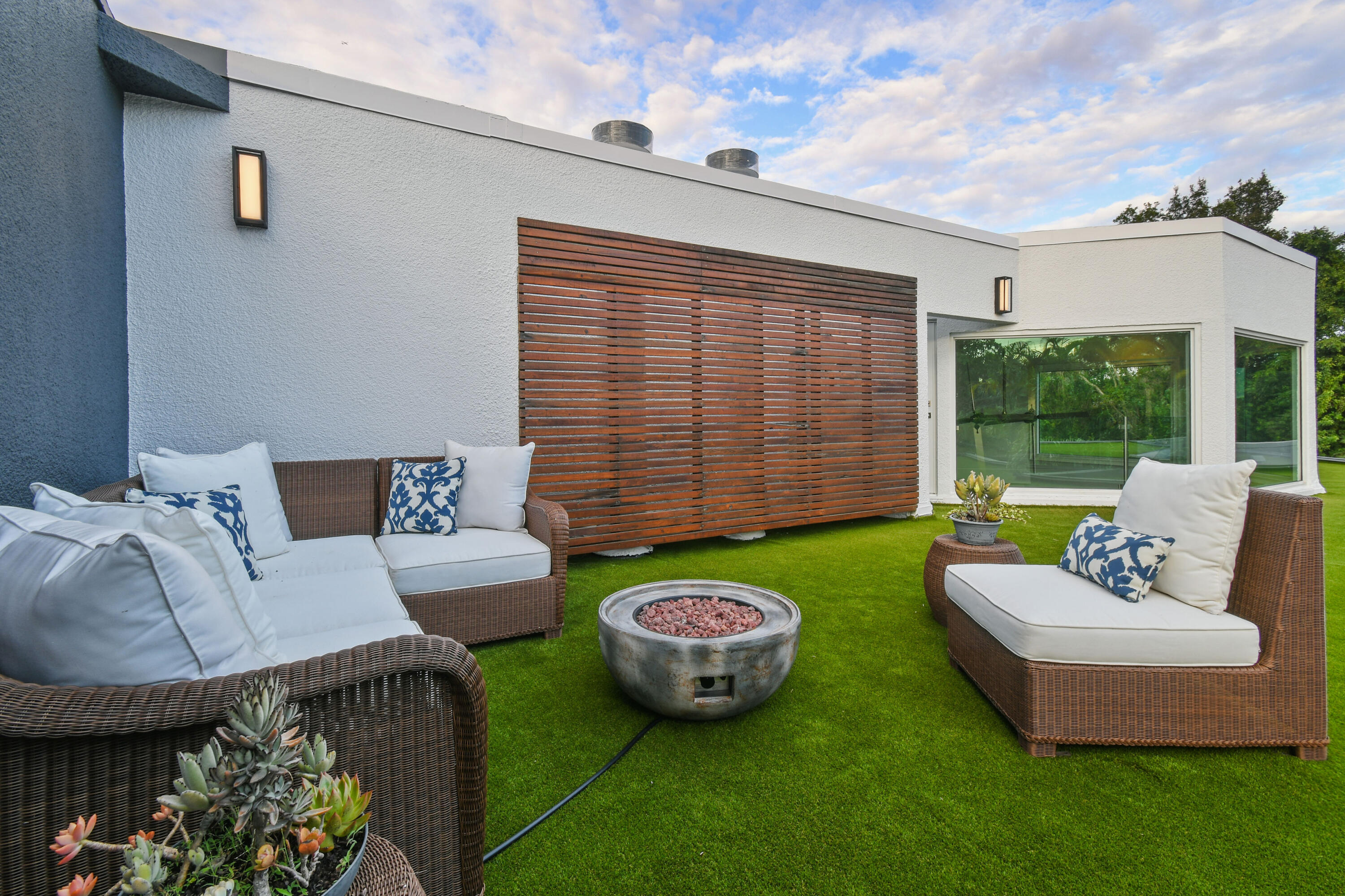 10561 Southeast Le Parc Jupiter, FL 33469 - Photo 6 of 80 a view of a patio with couches table and chairs and potted plants