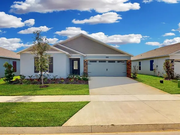 a front view of house with a garden