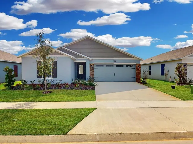 a front view of house with a garden