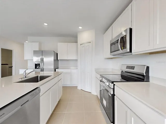 a kitchen that has a sink and a stove