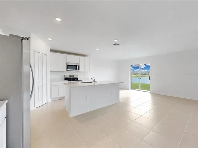 a kitchen with stainless steel appliances a refrigerator and a stove top oven