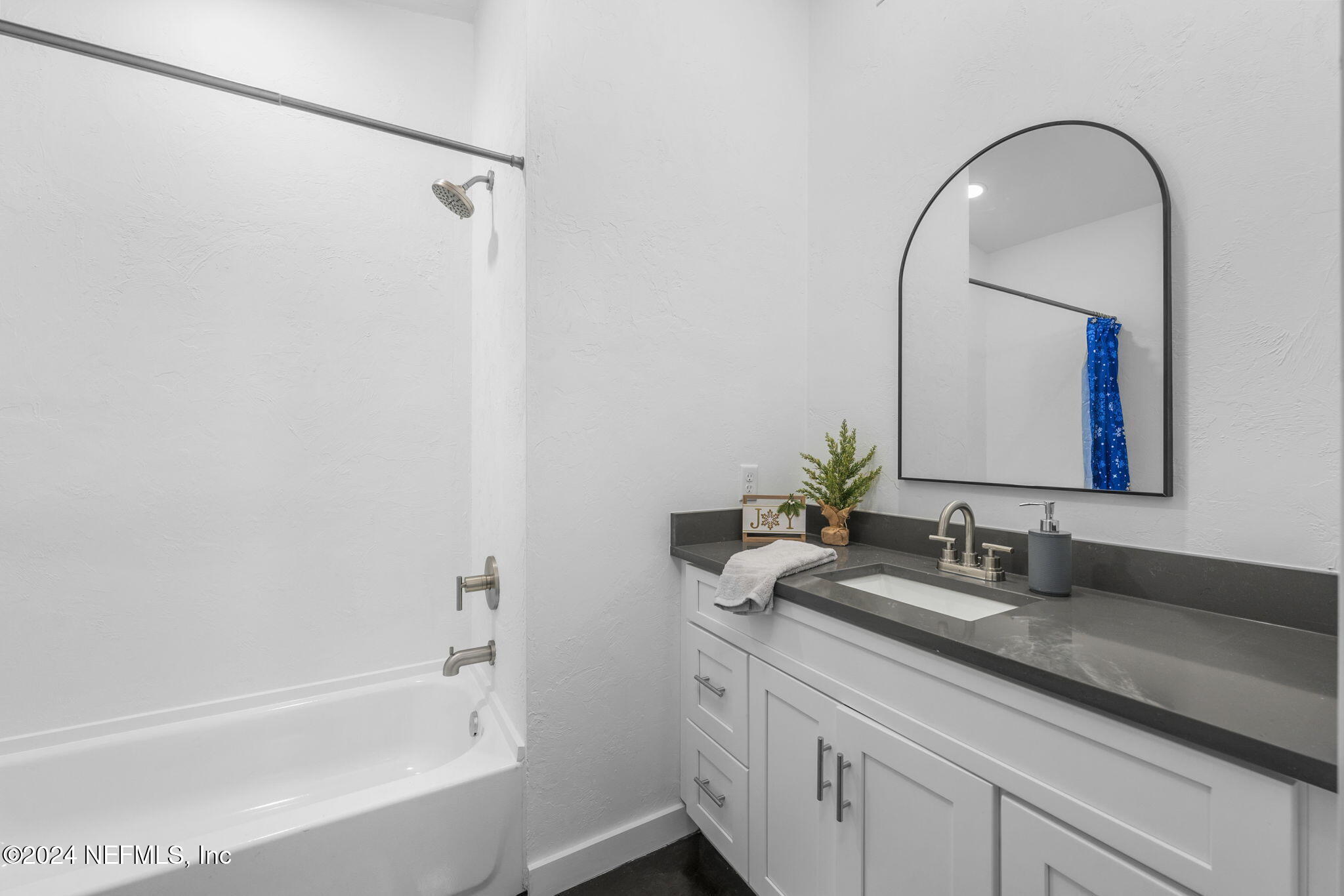 1409 High Street Palatka, FL 32177 - Photo 15 of 23 a bathroom with a granite countertop sink a mirror and a bathtub