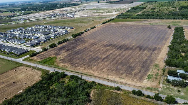 a view of a river and a yard with large trees