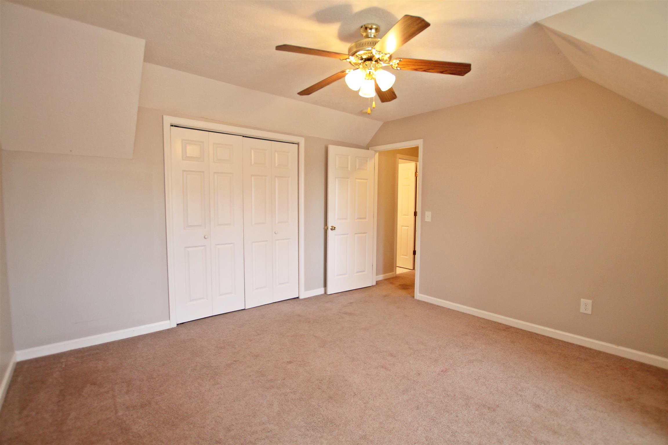 808 Hunters Crossing Lane Springfield, TN 37172 - Photo 19 of 30 an empty room with a chandelier fan and windows