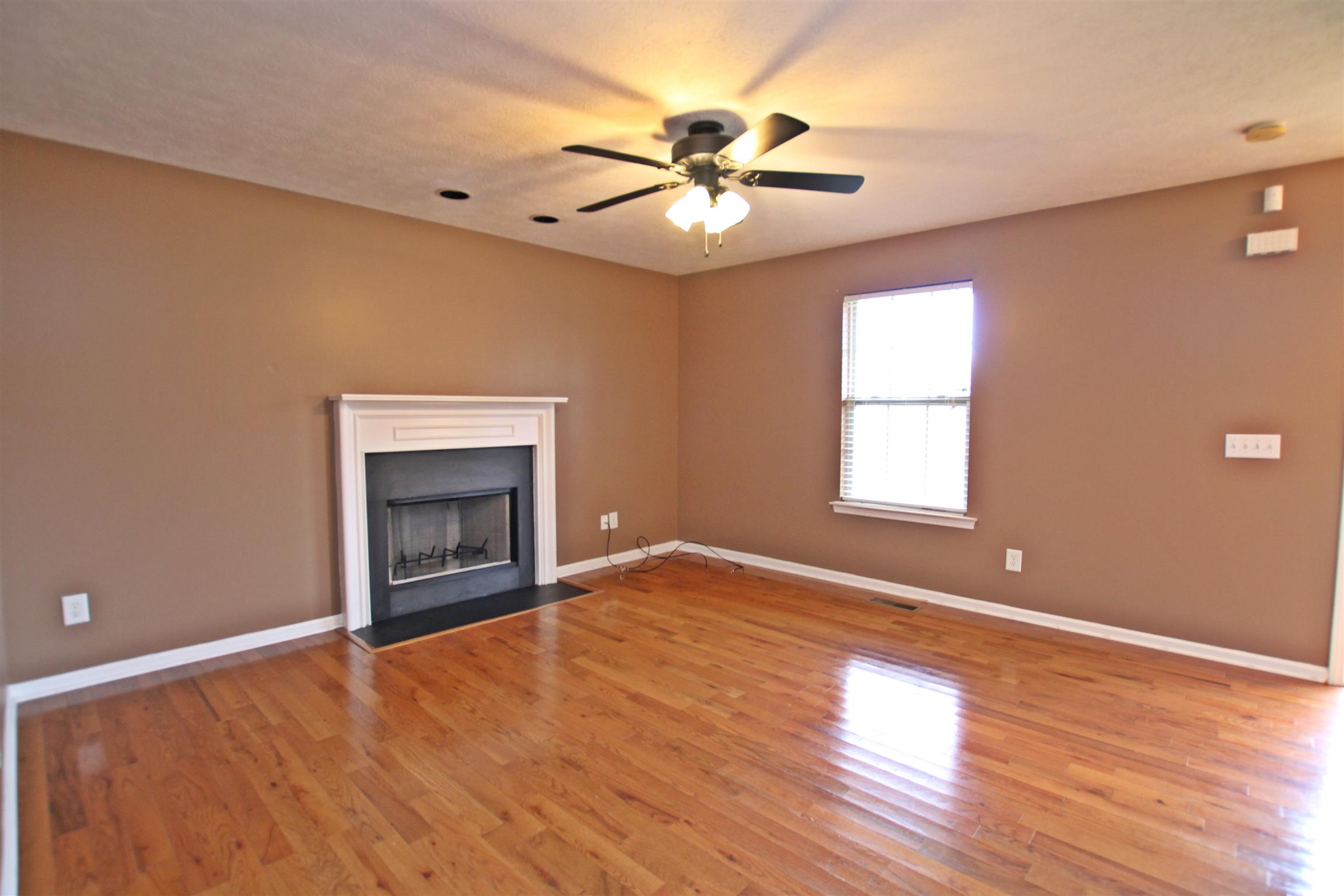 808 Hunters Crossing Lane Springfield, TN 37172 - Photo 5 of 30 an empty room with windows and fireplace