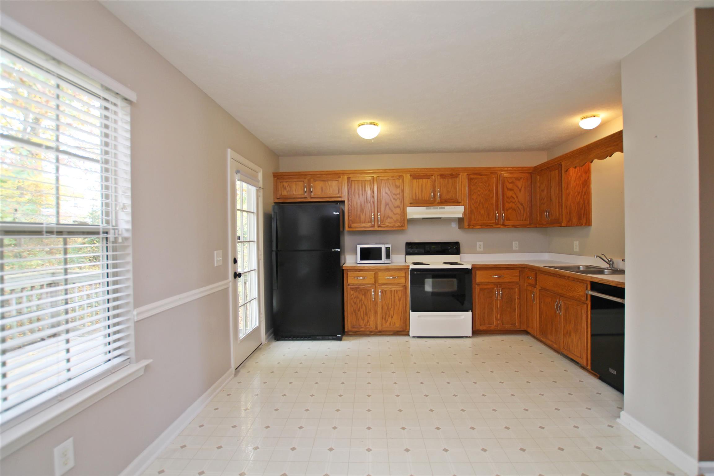 808 Hunters Crossing Lane Springfield, TN 37172 - Photo 6 of 30 a kitchen with stainless steel appliances kitchen island granite countertop a refrigerator and a stove top oven